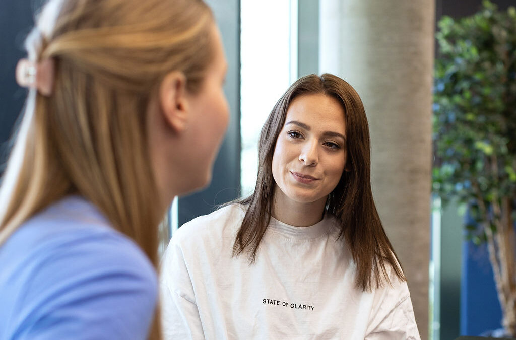 two girls talking face to face